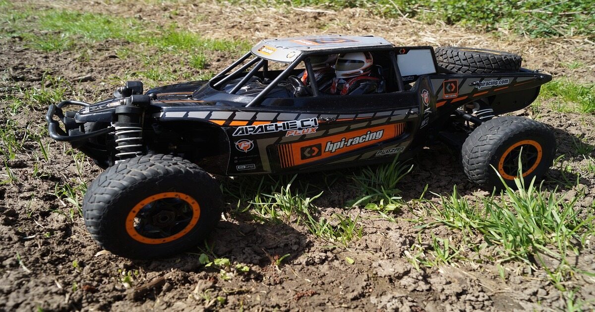 An image of a radio-controlled car in a field. 